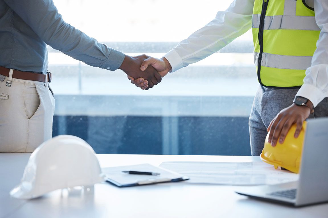 construction project manager shaking hands with client